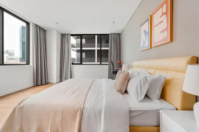 a white bedroom with a large bed and windows at Blueground Kuala Lumpur pool nr KL Tower KUL-5 in Kuala Lumpur