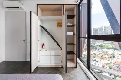 a bedroom with a bed and a large window at Blueground Kuala Lumpur rooftop pool nr KLCC KUL-6 in Kuala Lumpur