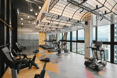 a gym with treadmills and elliptical machines at Blueground Kuala Lumpur rooftop pool nr KLCC KUL-7 in Kuala Lumpur