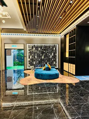 a lobby with a table with a blue object on it at Majestic Residence KLCC By AFA in Kuala Lumpur