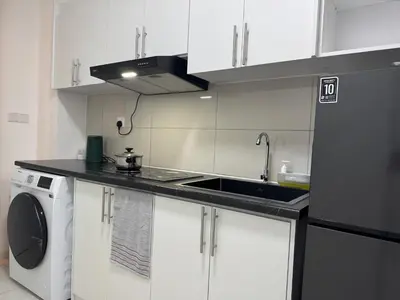 a kitchen with white cabinets and a sink and a dishwasher at Majestic Residence KLCC By AFA in Kuala Lumpur