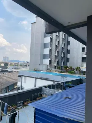 a building with a swimming pool in front of a building at nuvea Suites in Kuala Lumpur
