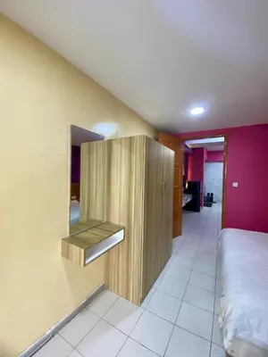 a bedroom with a bed and a cabinet in it at nuvea Suites in Kuala Lumpur