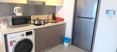 a kitchen with a washing machine and a refrigerator at Agile Twilight Residence Apartment in Kuala Lumpur