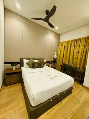 a bedroom with a bed with a ceiling fan at Lucentia Cozy Comfort Infinity Pool Suites in Kuala Lumpur