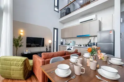 a kitchen and a living room with a table and a couch at Isola KLCC By Feel Home in Kuala Lumpur