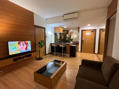 a living room with a couch and a flat screen tv at Suit Unit at Dua Sentral in Kuala Lumpur