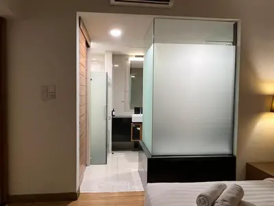 a bedroom with a white bed and a bathroom at Suit Unit at Dua Sentral in Kuala Lumpur
