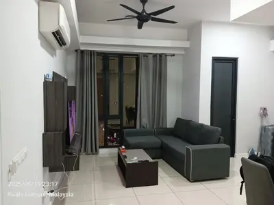 a living room with a couch and a ceiling fan at Sentral Residency KL sentral in Kuala Lumpur