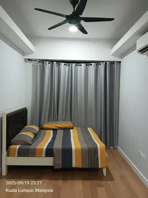 a bedroom with a bed and a ceiling fan at Sentral Residency KL sentral in Kuala Lumpur