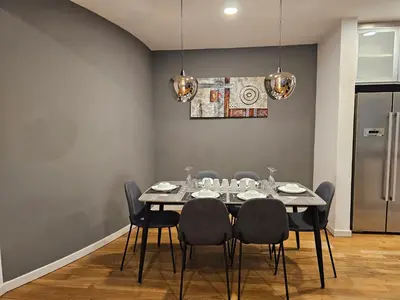 a dining room with a table and chairs at Cozy Spacious Loft St Mary Bukit Bintang Pavilion in Kuala Lumpur