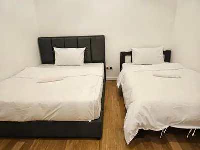 two beds sitting next to each other in a room at Cozy Spacious Loft St Mary Bukit Bintang Pavilion in Kuala Lumpur