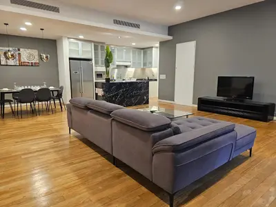 a living room with a couch and a dining room at Cozy Spacious Loft St Mary Bukit Bintang Pavilion in Kuala Lumpur