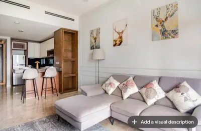 a living room with a couch and a kitchen at Luxury Living Hostel in Kuala Lumpur