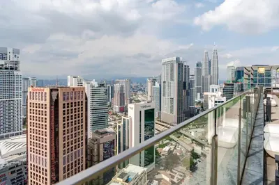 a view of a city skyline from a balcony at Luxury Living Hostel in Kuala Lumpur