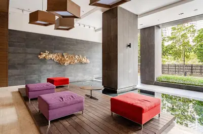 a lobby with purple and red stools and a table at Luxury Living Hostel in Kuala Lumpur