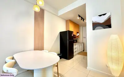 a kitchen with a white table and a refrigerator at The Heart in Kuala Lumpur City - Majestic Residences in Kuala Lumpur
