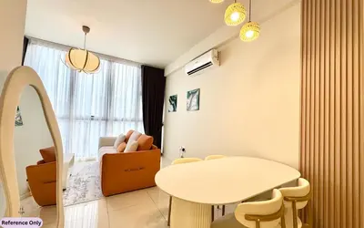a living room with a table and a chair at The Heart in Kuala Lumpur City - Majestic Residences in Kuala Lumpur