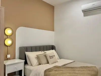 a small bedroom with a bed with white sheets and pillows at Majestic Residence KL in Kuala Lumpur