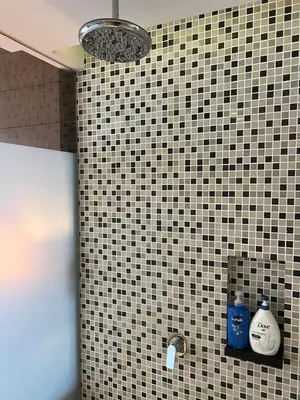 a bathroom with a black and white tiled wall at Super Tang Jaya in Kuala Lumpur