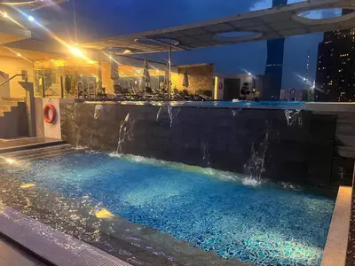 a swimming pool with a waterfall in a building at Super Tang Jaya in Kuala Lumpur