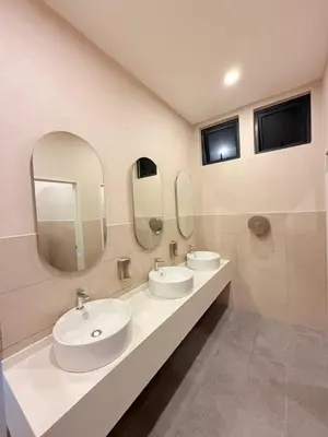 a bathroom with two sinks and two mirrors at Majestic Suites KLCC By Fortune in Kuala Lumpur
