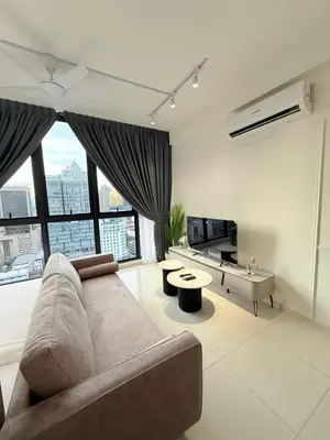 a living room with a couch and a large window at Majestic Suites KLCC By Fortune in Kuala Lumpur
