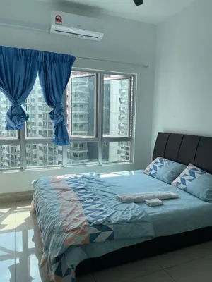 a bedroom with a bed and a large window at Warm & Spacious 2BR Apartment in Kuala Lumpur
