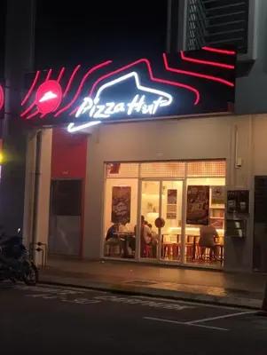 a pizza hut sign on the side of a building at Warm & Spacious 2BR Apartment in Kuala Lumpur