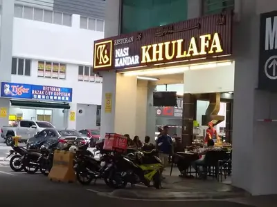 a group of motorcycles parked outside of a restaurant at Warm & Spacious 2BR Apartment in Kuala Lumpur