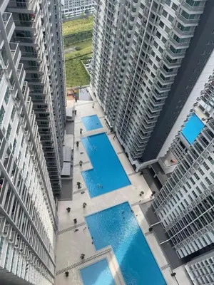 an overhead view of two tall buildings with swimming pools at Warm & Spacious 2BR Apartment in Kuala Lumpur