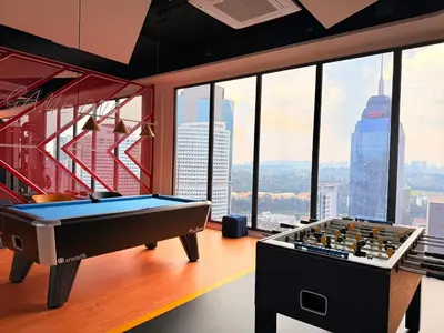 a pool table in a room with a view of the city at Majestic Serviced Suites KLCC in Kuala Lumpur