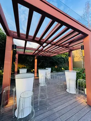 a pergola with tables and chairs on a deck at Majestic Serviced Suites KLCC in Kuala Lumpur
