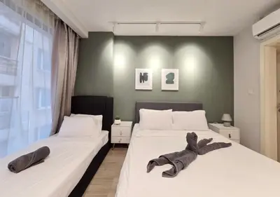 two beds in a bedroom with towels on them at Kuala Lumpur Bintang Fairlane #107 TRX Pavilion KL in Kuala Lumpur