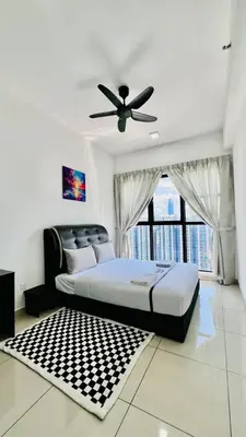 a bedroom with a bed and a ceiling fan at Trion Homestay -KL in Kuala Lumpur