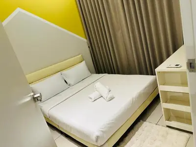 a small bedroom with a bed with two pillows at Trion Homestay -KL in Kuala Lumpur