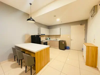 a kitchen with a table and chairs in a room at Trion Homestay -KL in Kuala Lumpur