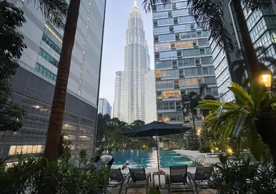 a pool in the middle of a city with a tall building at MARC Residence KLCC by VastHaven in Kuala Lumpur