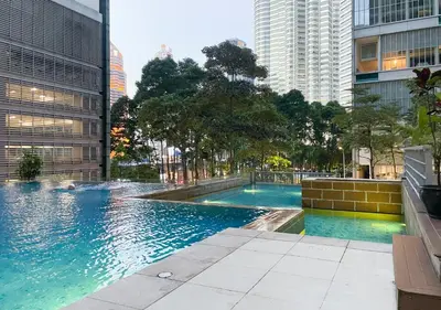 a swimming pool in a city with tall buildings at MARC Residence KLCC by VastHaven in Kuala Lumpur