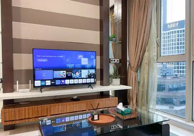 a living room with a large television on a shelf at MARC Residence KLCC by VastHaven in Kuala Lumpur