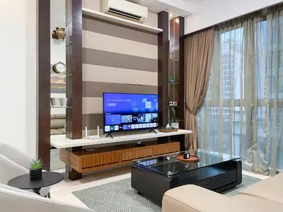 a living room with a flat screen tv on a wall at MARC Residence KLCC by VastHaven in Kuala Lumpur