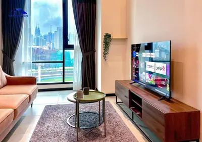 a living room with a television and a couch at OPUS Residences Kuala Lumpur by VastHaven in Kuala Lumpur