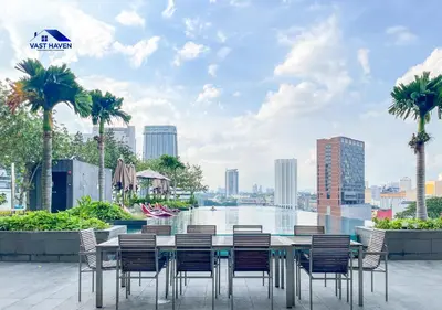a table and chairs with a view of a river at OPUS Residences Kuala Lumpur by VastHaven in Kuala Lumpur