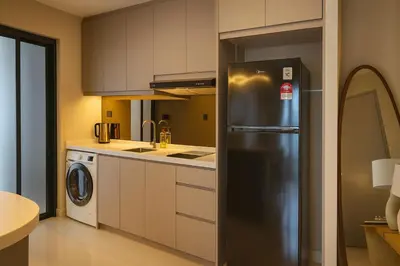 a kitchen with a stainless steel refrigerator at Novo Ampang by Dormeo Destinations - Near KLCC and TRX in Kuala Lumpur