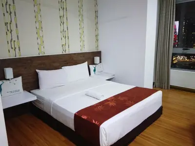 a bedroom with a large white bed and a window at Mykl Family suite Taragon in Kuala Lumpur