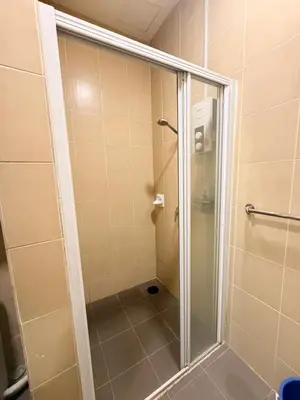 a shower with a glass door in a bathroom at Mykl Family suite Taragon in Kuala Lumpur