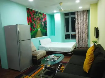 a living room with a couch and a refrigerator at Mykl Family suite Taragon in Kuala Lumpur