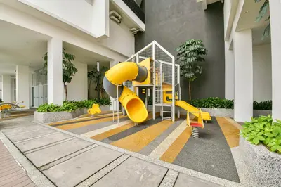 a playground in a building with a yellow slide at KLCC Quill Residences by Avery #Located in the City Center #10 mins walk to Twin Towers #Infinity pool#\u4e2d\u82f1\u6587\u623f\u4e1c in Kuala Lumpur