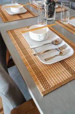 a table set with plates and silverware on a table at Ancestry 3BR M Vertica MRT Access by RumaBnB in Kuala Lumpur