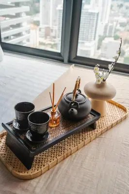 a tray with cups and utensils on a table at Ancestry 3BR M Vertica MRT Access by RumaBnB in Kuala Lumpur